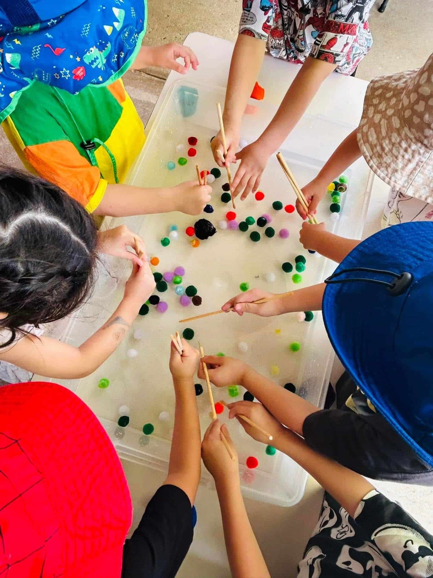 Children’s hands busy with a colourful craft activity