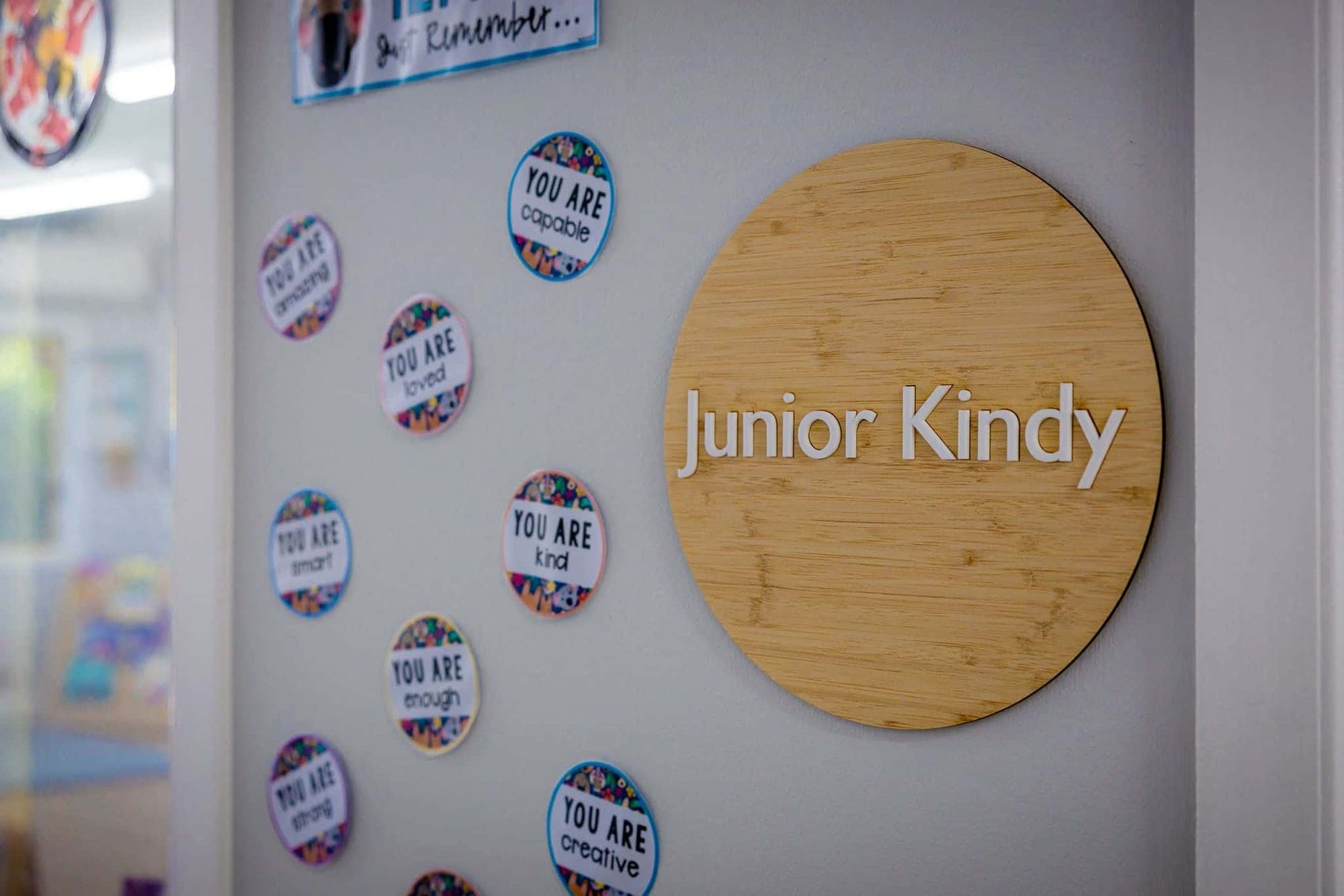 Timber Junior Kindy sign surrounded by ‘You are…’ affirmation badges