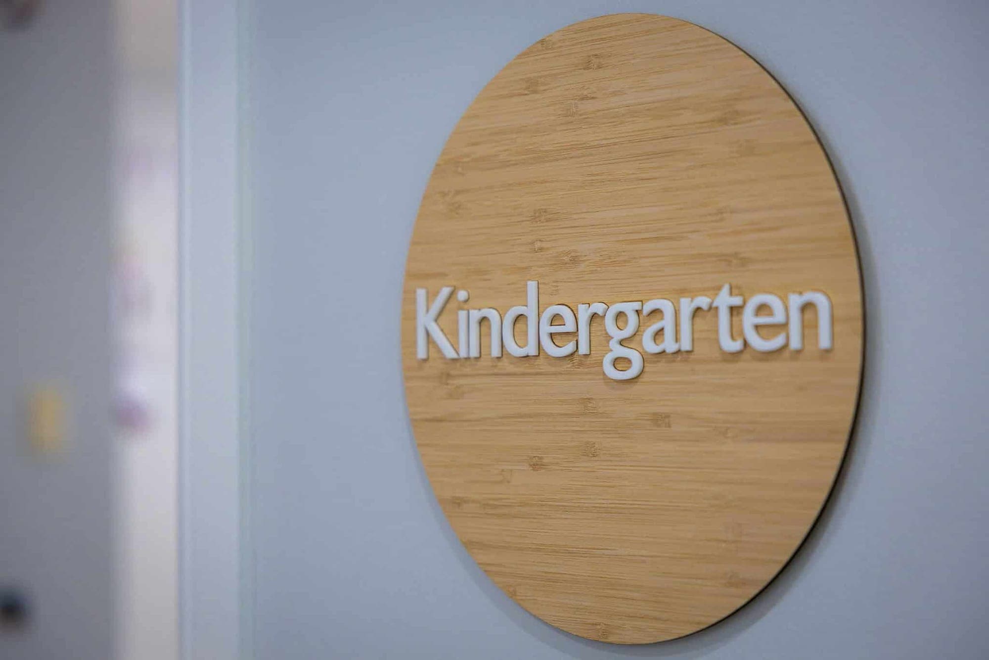 Timber Kindergarten sign on a soft grey wall